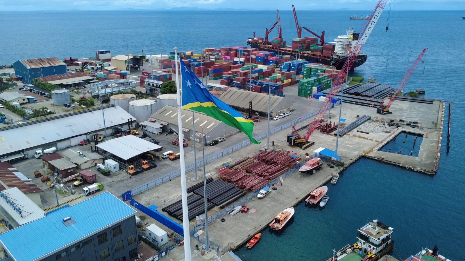 Aerial view of Honiara port with the Solomon Islands flag flying over the container yard
