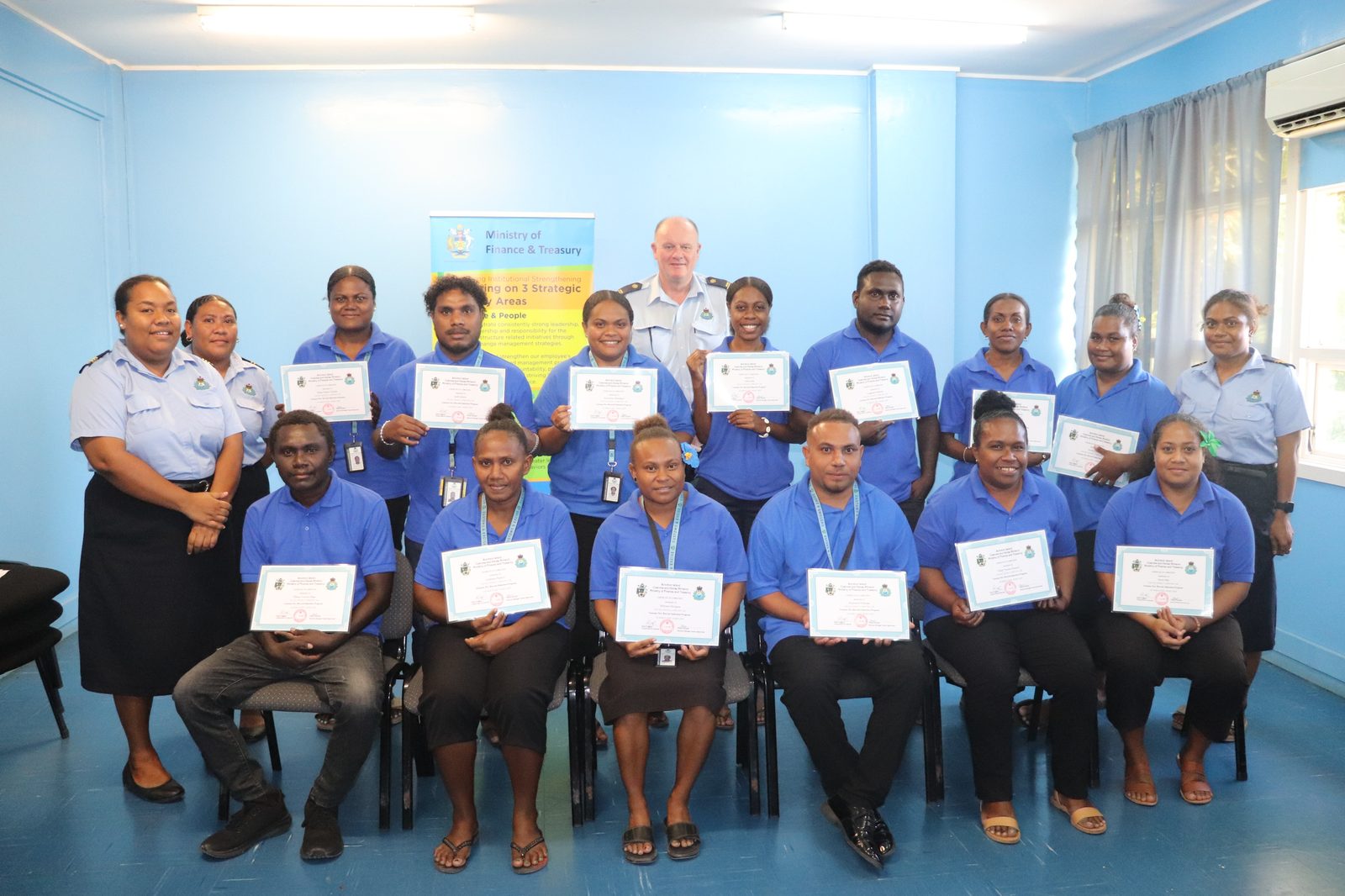 SICED recruits and trainers pose with completion certificates